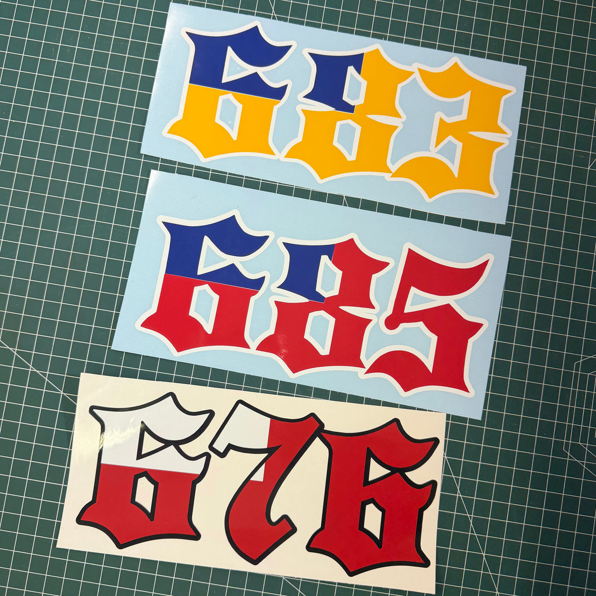 Three Pacific area code car decals showing 683 (Niue) in blue and yellow, 685 (Samoa) in blue and red, and 676 (Tonga) in red and white gothic lettering